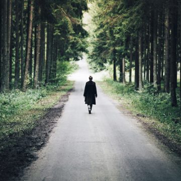 Woman walking on a road in the forest | thecozyapron.com