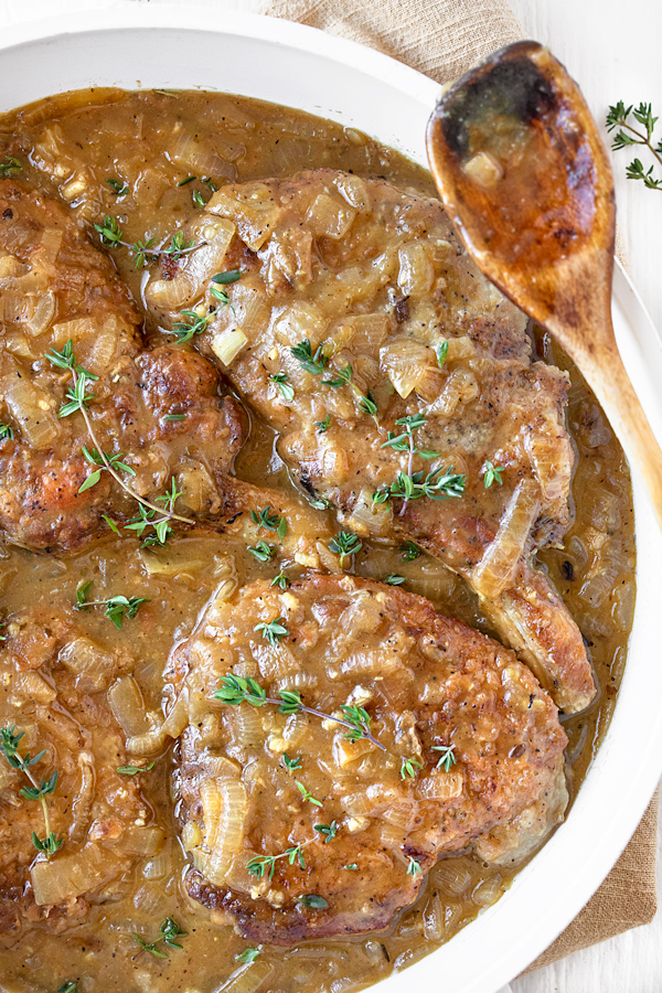 Smothered Pork Chops in a Savory Pan Sauce | thecozyapron.com