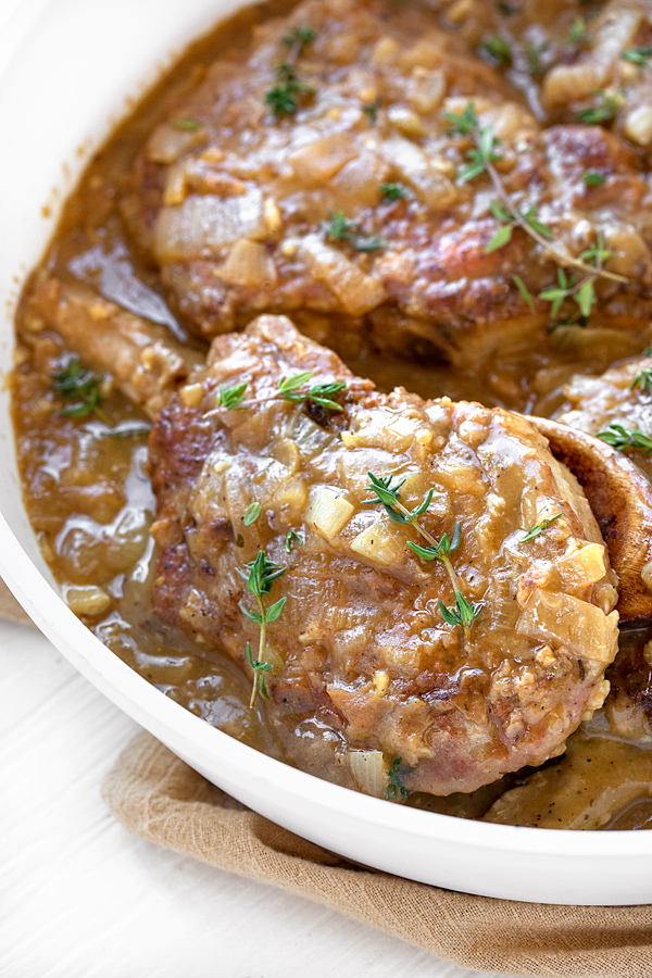 Smothered Pork Chops in a Savory Pan Sauce | thecozyapron.com