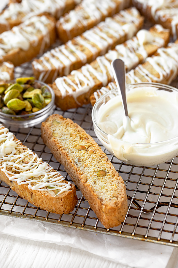 Biscotti on Wire Rack Drizzled with White Chocolate | thecozyapron.com