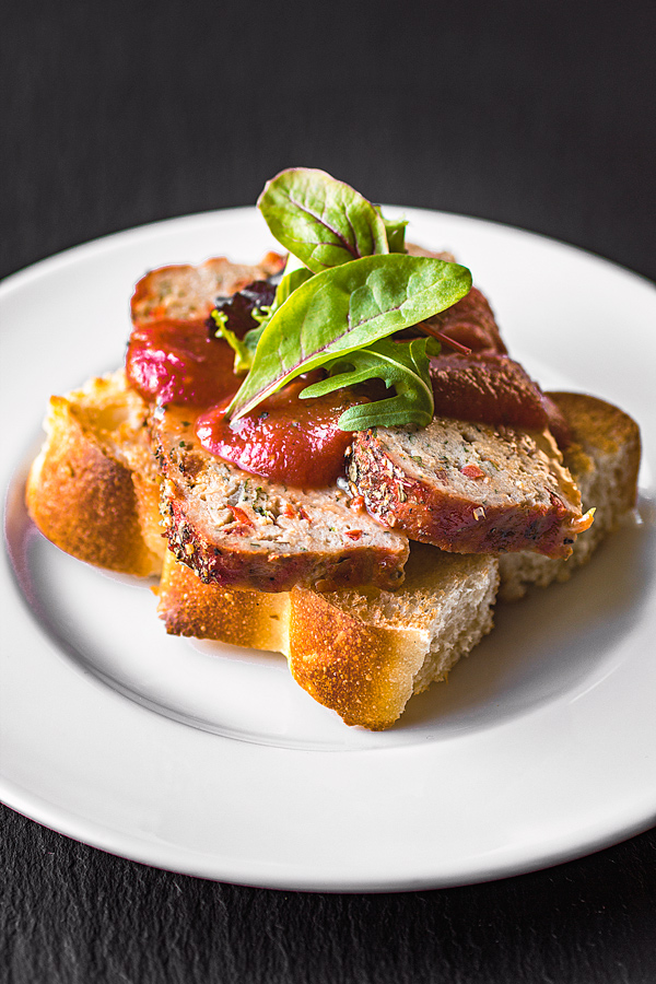 turkey meatloaf with tomato glaze and fresh greens on a slice of toast