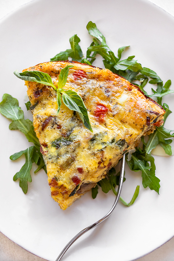 Slice of Crustless Quiche with Greens | thecozyapron.com
