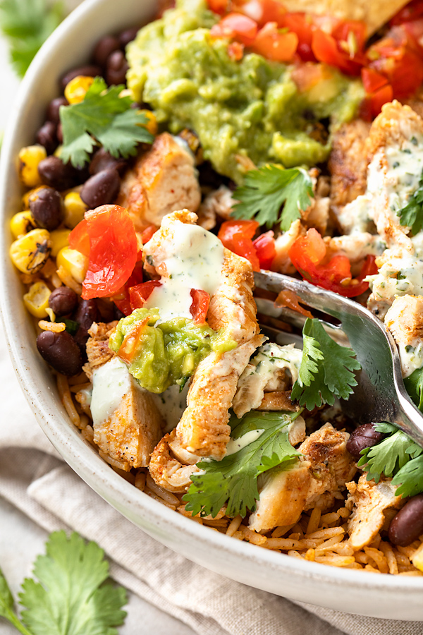Close Up of Chicken Burrito Bowl with a Fork | thecozyapron.com