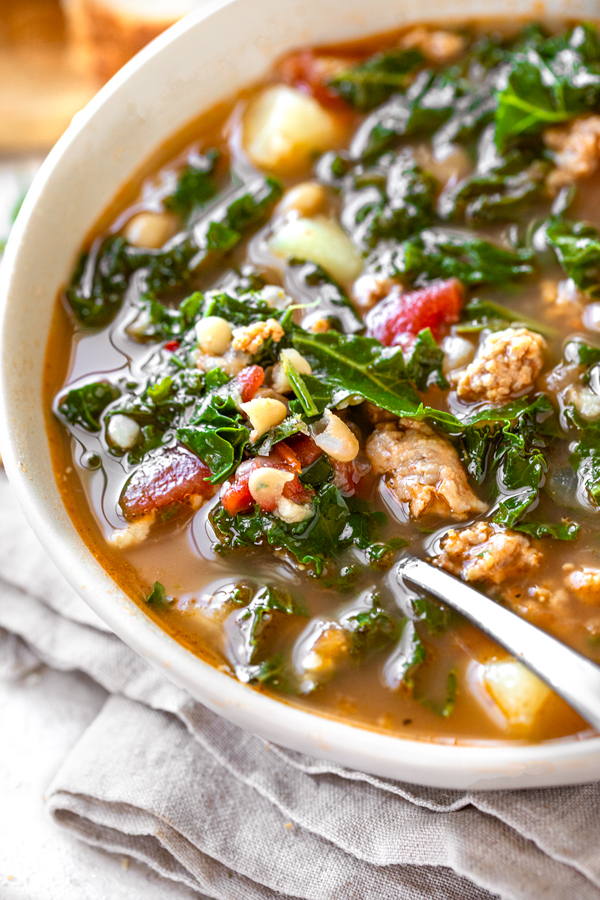 Tuscan Kale and Sausage Soup in a Bowl | thecozyapron.com