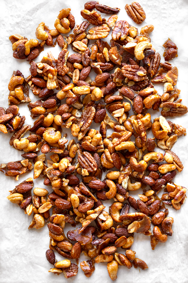 Buttered Toffee Candied Nuts on Parchment Paper | thecozyapron.com