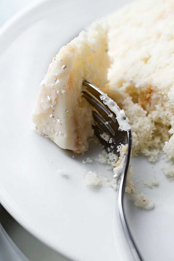 Piece of a slice of Eggnog Cake with Fluffy Eggnog Frosting on a fork | thecozyapron.com