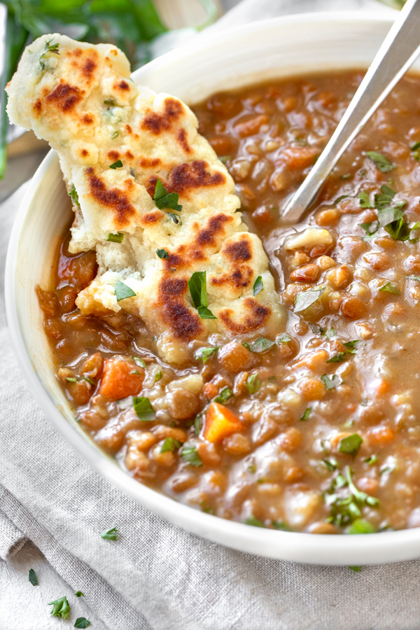Flatbread Dipped in Bowl of Lentil Soup | thecozyapron.com