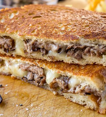 Steak and Mushroom Grilled Cheese sliced in half | thecozyapron.com
