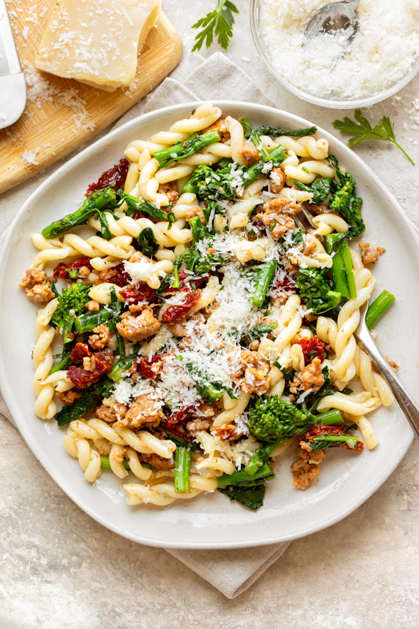 sausage and broccoli rabe pasta topped with cheese | thecozyapron.com