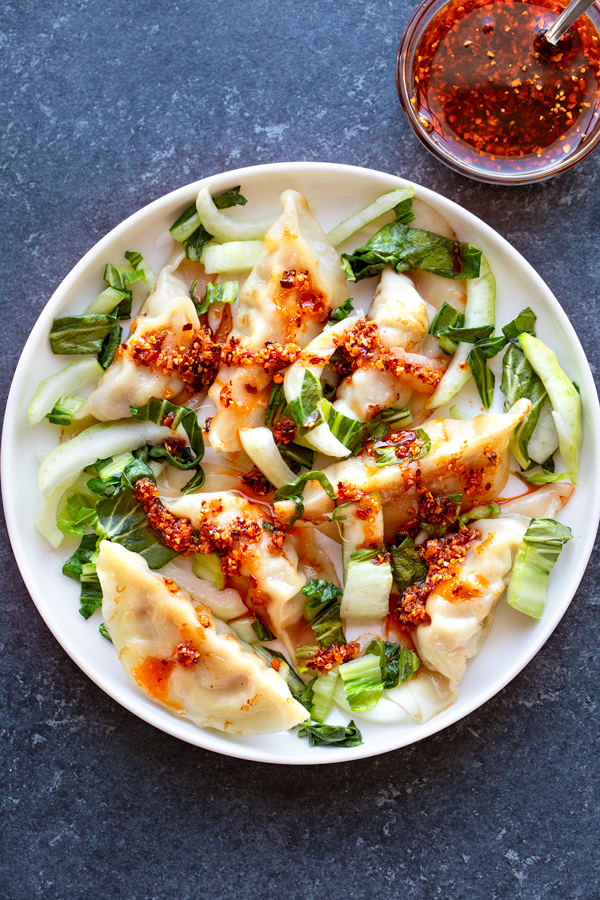 Chili Crisp drizzled over Potstickers and bok choy | thecozyapron.com