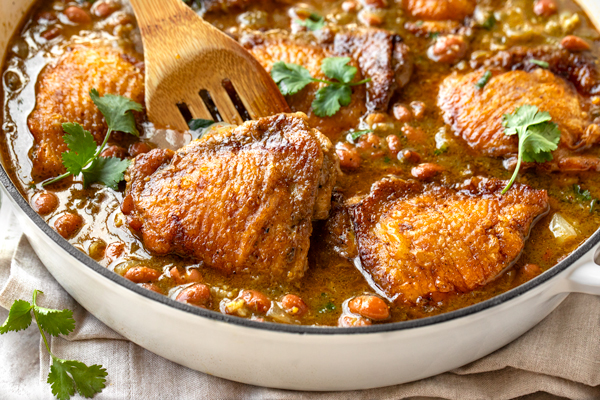 Salsa Verde Chicken with Beans in a large braising pan | thecozyapron.com