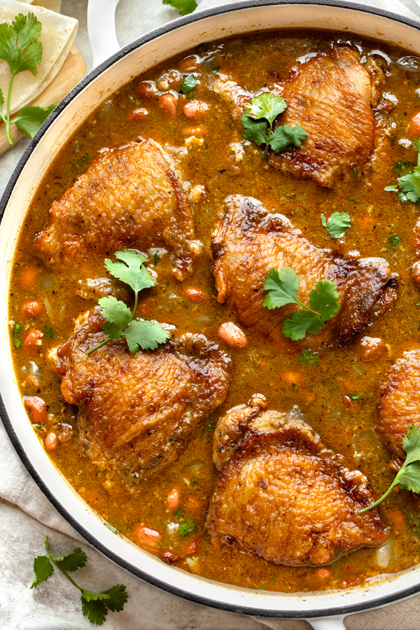 Salsa Verde Chicken with Beans in a large braising pan | thecozyapron.com