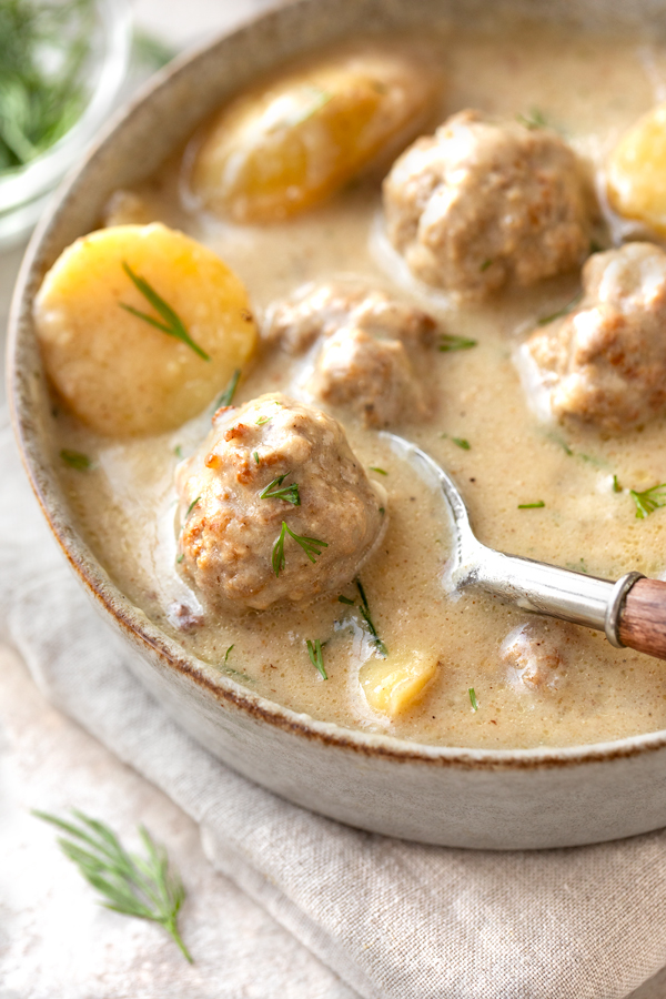 Closeup on a spoonful of Swedish Meatball Soup | thecozyapron.com