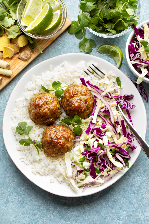 Pork Meatballs with Ginger and Lemongrass, on a bed of rice with Chili-lime slaw | thecozyapron.com