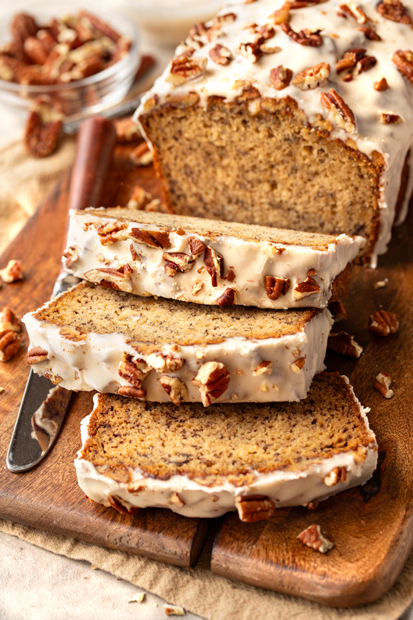 A freshly baked loaf of Buttered Pecan Banana Bread sliced and ready to enjoy | thecozyapron.com