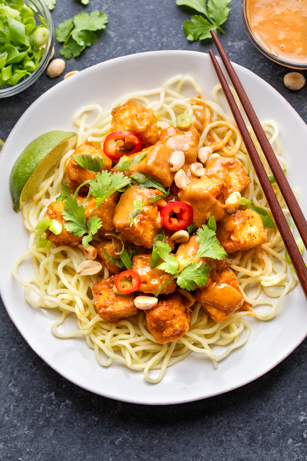 Crispy Tofu with Spicy Peanut Sauce on a bed of noodles | thecozyapron.com