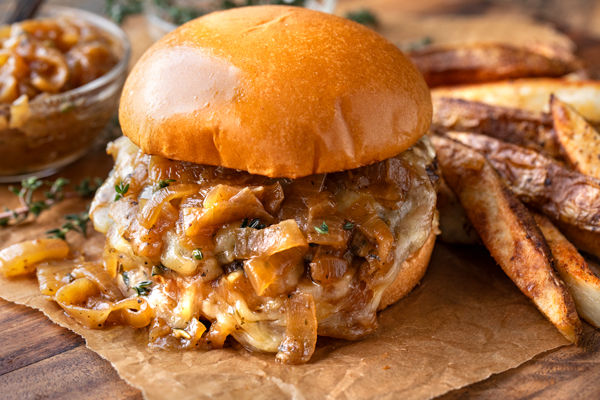 A French Onion Burger with its melted cheese and caramelized onion sauce! | thecozyapron.com