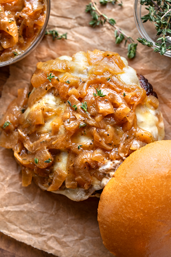 Overhead close-up of caramelized onion sauce on an open-faced French Onion Burger | thecozyapron.com