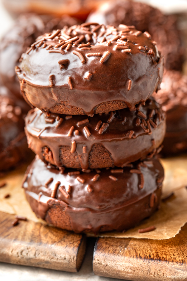 A stack of three freshly baked Chocolate Glazed Donuts | thecozyapron.com