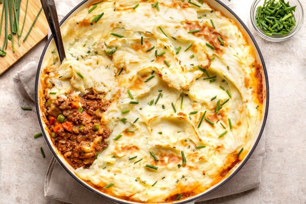 A spoonful of Cottage Pie with Cheddar-Chive Mashed Potatoes fresh out of the oven | thecozyapron.com