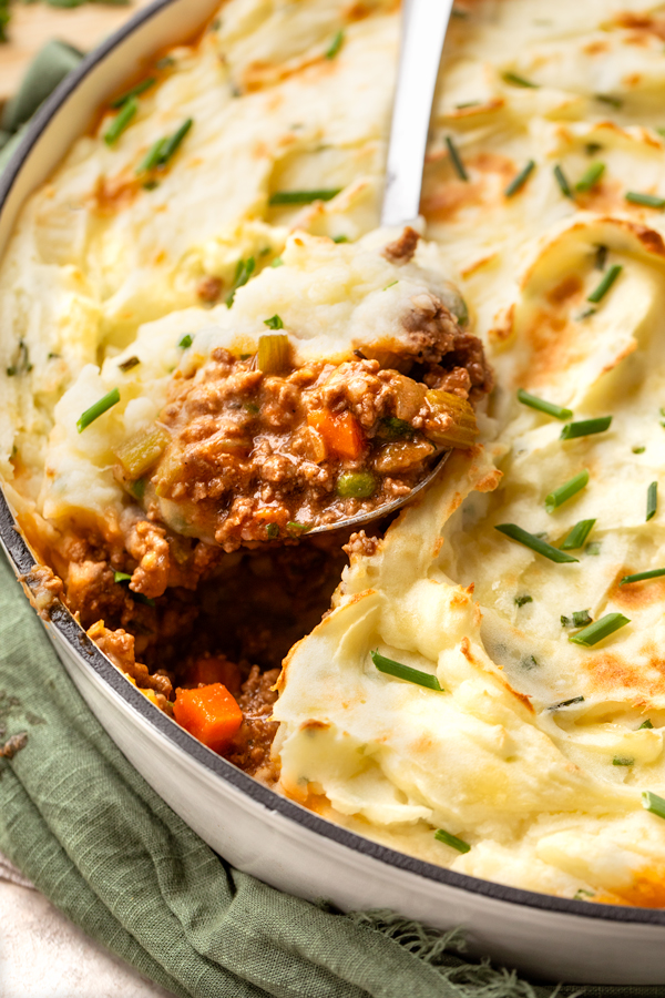Closeup on a spoonful of Cottage Pie with Cheddar-Chive Mashed Potatoes | thecozyapron.com