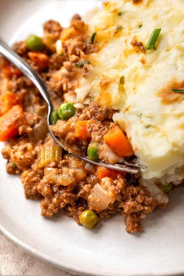Closeup on a forkful of Cottage Pie with Cheddar-Chive Mashed Potatoes | thecozyapron.com