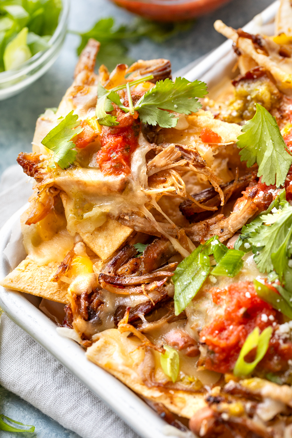 Closeup on Pulled Pork Nachos on a Sheet Pan, fresh out of the oven | thecozyapron.com