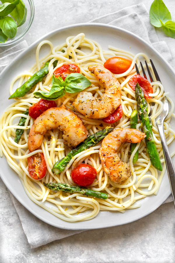 Sheet Pan Shrimp served on a bed of spaghetti | thecozyapron.com