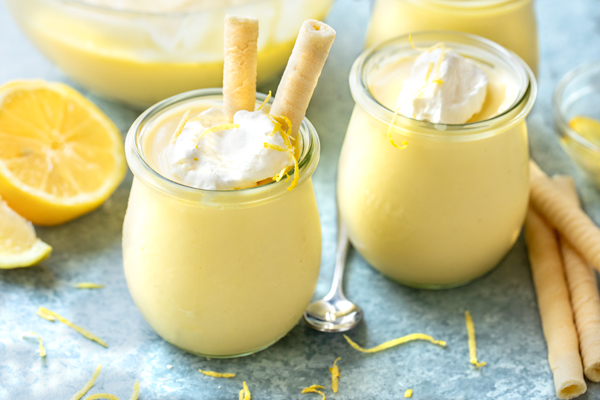 Two jars of freshly made Lemon Pudding, with a couple lemon cookie straws | thecozyapron.com