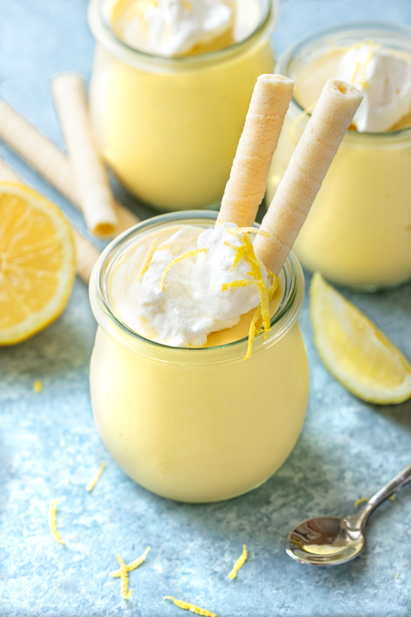 A jar of freshly made Lemon Pudding, with a couple lemon cookie straws | thecozyapron.com