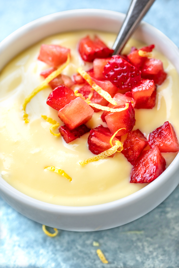 A bowl of Lemon Pudding with diced strawberries | thecozyapron.com