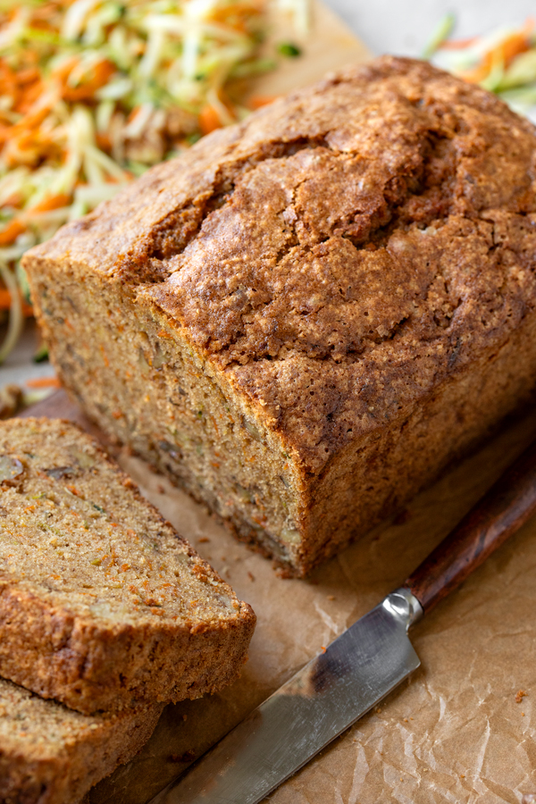 Closeup o freshly sliced Zucchini Carrot Bread on a cutting board | thecozyapron.com
