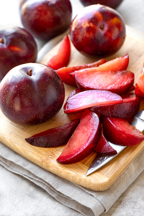 Sliced fresh red plums for Plum Cake | thecozyapron.com