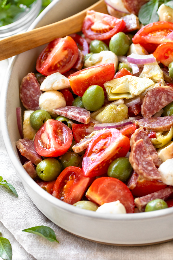 A beautiful closeup view of fresh Antipasto Salad in a serving bowl | thecozyapron.com