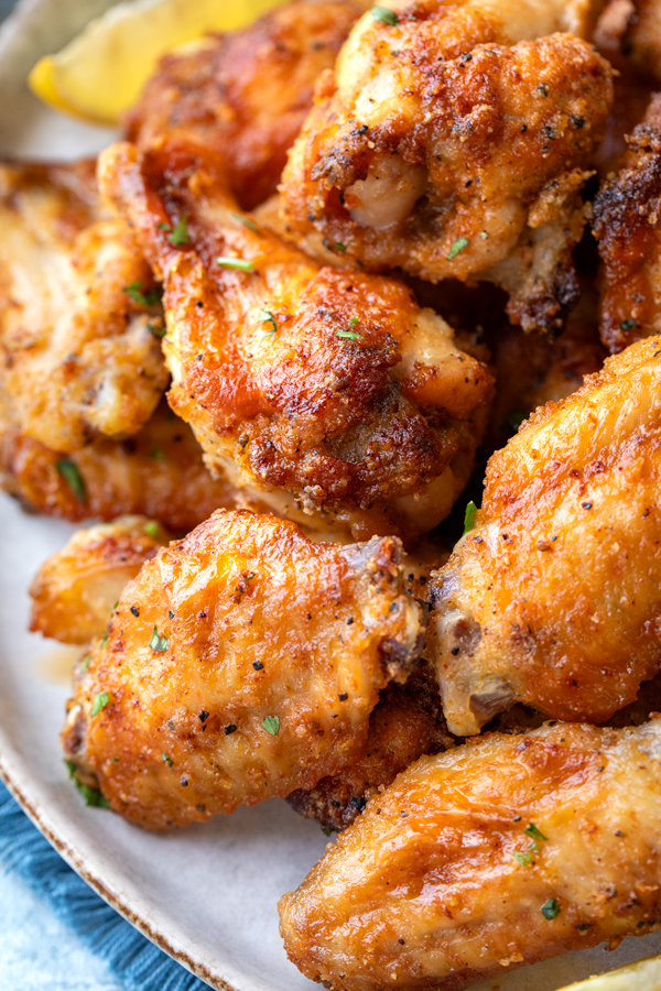 Closeup on a fresh platter of homemade Lemon Pepper Wings | thecozyapron.com
