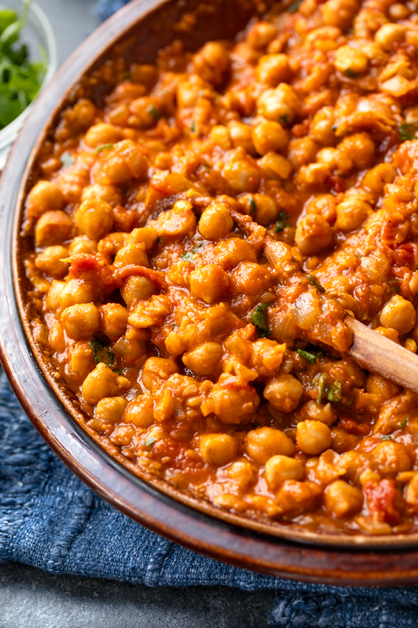 Closeup on a serving dish full of Chana Masala | thecozyapron.com