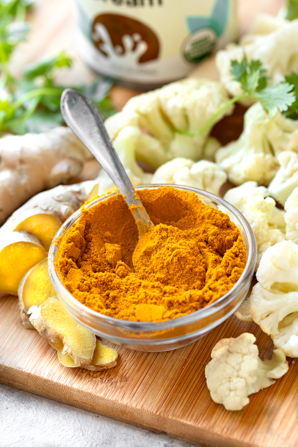 A ramekin of turmeric and the rest of the Ingredients for Golden Soup | thecozyapron.com