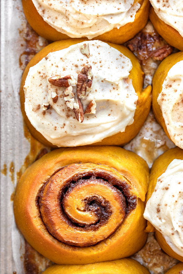 Overhead view of Pumpkin Cinnamon Rolls with Maple Spice Frosting, still in their pan | thecozyapron.com