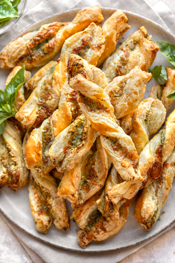A plate of stacked Cheese Twists | thecozyapron.com
