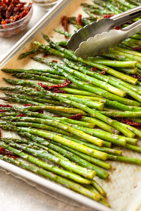 A baking tray full of fresh Oven Roasted Asparagus on Baking Sheet | thecozyapron.com