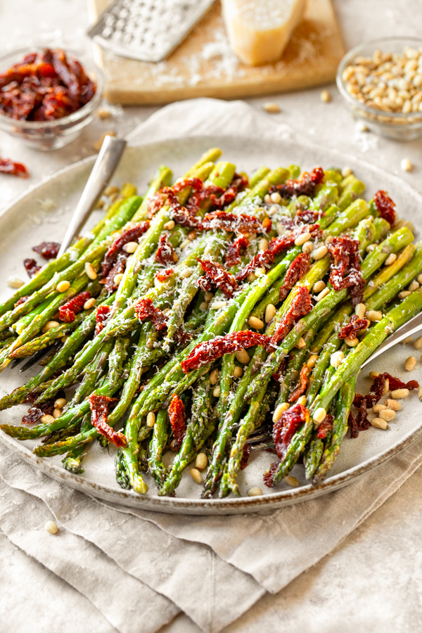 A beautiful serving platter full of Oven Roasted Asparagus | thecozyapron.com