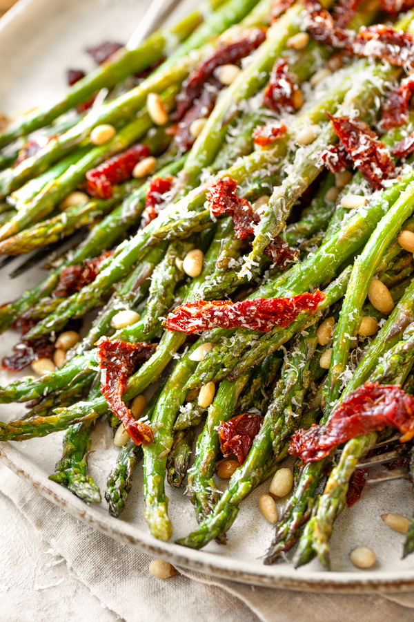Closeup on a beautiful serving platter full of Oven Roasted Asparagus | thecozyapron.com