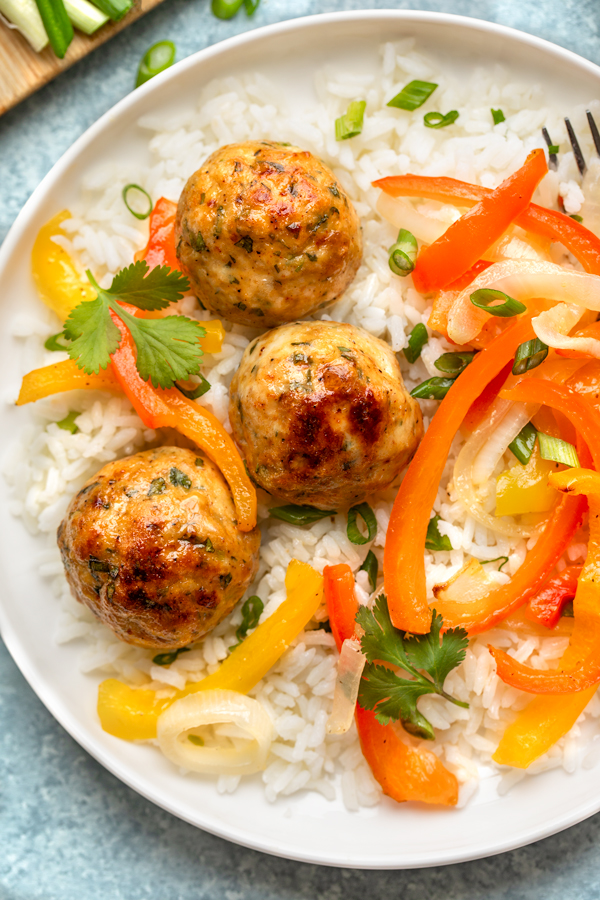 Overhead shot on a plate of Chicken Meatballs with Peppers and Onions over Rice | thecozyapron.com