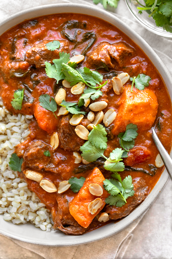 A closer overhead shot on a bowl of African Peanut Stew over rice | thecozyapron.com