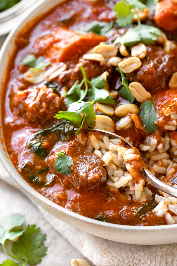 Closeup on a spoonful of African Peanut Stew over rice | thecozyapron.com