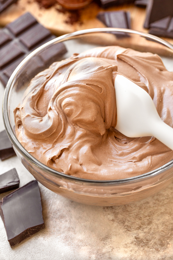 Easy Chocolate Mousse in a mixing bowl with big chunks of chocolate on the side | thecozyapron.com