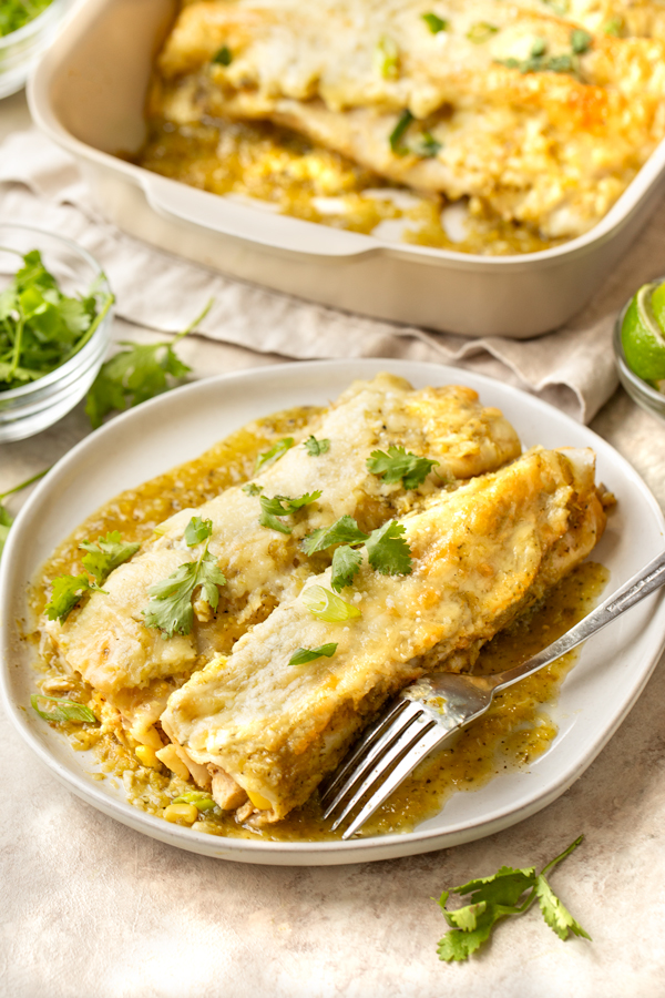 A serving of Salsa Verde Chicken Enchiladas on a Plate | thecozyapron.com