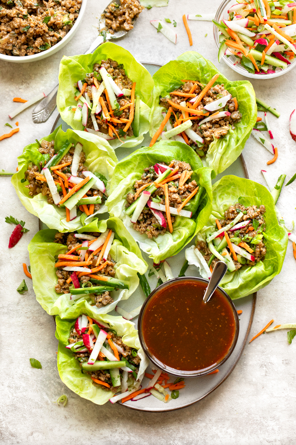 A platter of Pork Lettuce Wraps with sauce on the side | thecozyapron.com