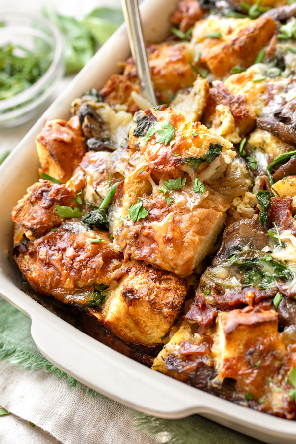 Breakfast Strata being served from a baking dish | thecozyapron.com
