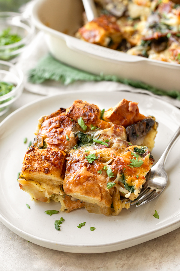 A serving of warm Breakfast Strata on a plate | thecozyapron.com